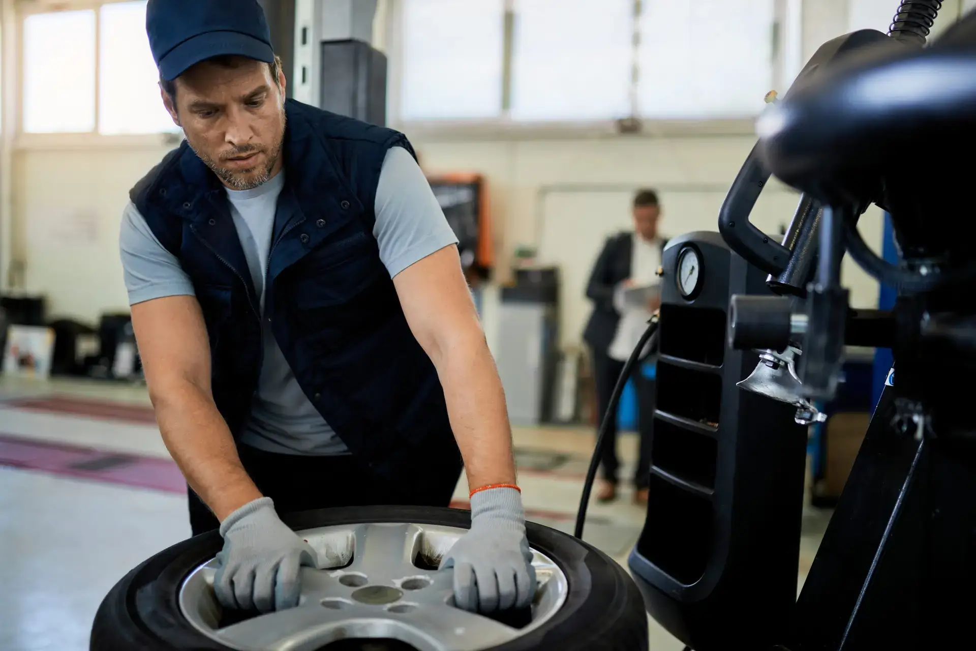 auto-mechanic-repairing-car-tire-in-a-workshop-2024-12-13-18-35-21-utc-scaled